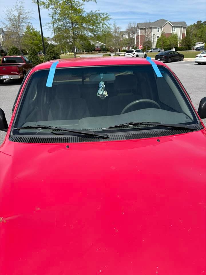 windshield replacement — red sedan — after